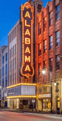 alabama is written on a large neon sign above a building