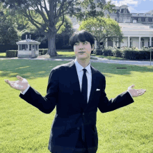 a man in a suit and tie is standing in front of the white house