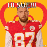 a man in a red jersey with the number 87 on it says hi sue
