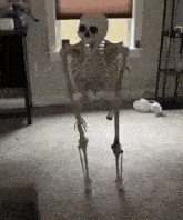 a skeleton is standing in a room with a fork in his mouth .