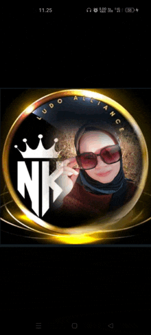 a woman wearing sunglasses and a hijab is in a circle with the letter nk on it