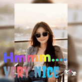 a picture of a woman wearing sunglasses with the words hmm very nice