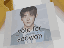 a poster that says vote for seowon with a picture of a young man