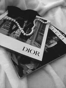 a black and white photo of a dior magazine