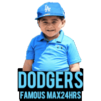 a young boy wearing a dodgers hat is sitting next to a sign that says dodgers famous max24hrs