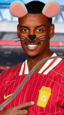 a man wearing a cat mask and a yellow trash can