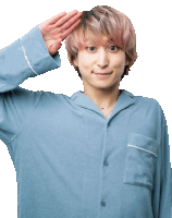 a man wearing a blue shirt salutes with his hand on his head