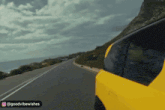 a yellow car is driving down a road with the words goodvibewishes on the bottom