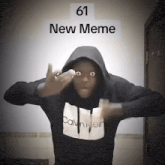 a man wearing a black calvin klein hoodie is making a funny face