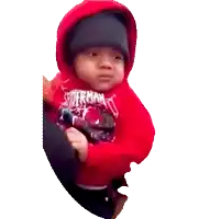 a baby wearing a red spiderman shirt