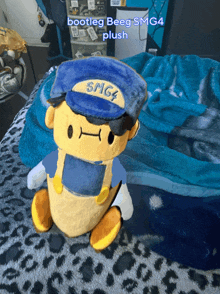 bootleg beeg smg4 plush is sitting on a bed