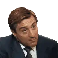 a man in a suit and tie is making a silly face