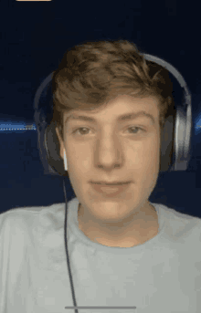 a young man wearing headphones and an airpod