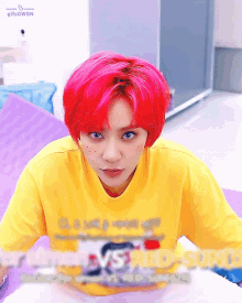 a girl with red hair is wearing a yellow shirt that says red-sunu