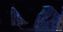 a man in a gold and silver costume is dancing on a stage .