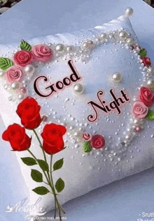 a pillow with roses and pearls on it and the words `` good night '' on it .