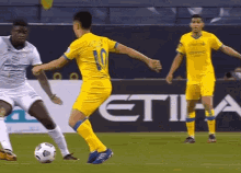 a soccer player with the number 10 on his back kicks the ball