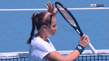 a woman on a tennis court with bein sports written on the screen