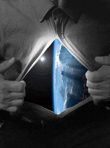 a person is ripping their shirt open to reveal the earth