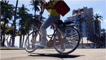 a person riding a bike with a bag on the back