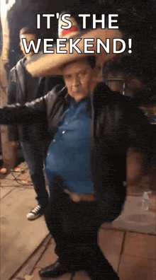 a man in a leather jacket is dancing with the words it 's the weekend written above him
