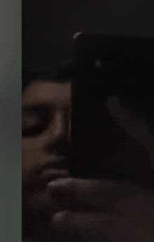 a person is holding a phone in their hand in the dark