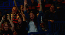 a man wearing a red hat that says ' washington ' on it is cheering with his arms in the air