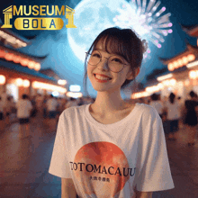 a woman wearing a totomacau t-shirt is smiling