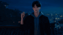 a man in a black jacket and blue hoodie stands in front of a city at night