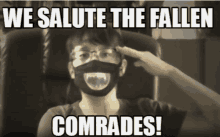 a man wearing a mask salutes with the words " we salute the fallen comrades "