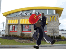 a mcdonald 's restaurant with a cartoon character standing in front of it