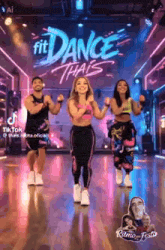 a group of people are dancing on a stage in front of a sign that says fit dance thais .