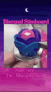 a person is holding a spoon with a flower on it that says bisexual stimbroard on it