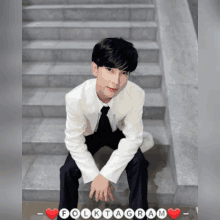 a man in a white jacket sits on a set of stairs with folktagram written on the bottom