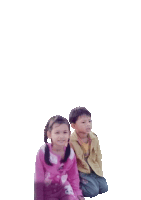 a boy and a girl sit next to each other on a white background