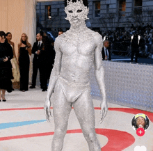 a man in a silver bodysuit with a cat mask on his face