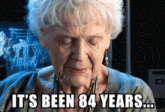 an elderly woman with her eyes closed and the words it 's been 84 years