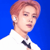 a close up of a person wearing a white shirt and tie