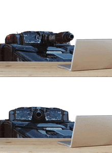 a laptop sits on a wooden desk next to a tank