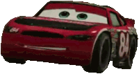 a red racing car from the movie cars is sitting on a white surface .