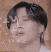 a close up of a person 's face with mathematical equations written on the board behind them