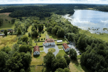 an aerial view of a large house surrounded by trees