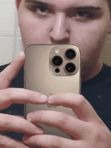 a man is taking a selfie with an iphone