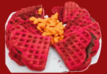 a plate of red waffles with a slice taken out of one