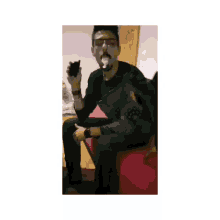 a man sitting on a couch with a dog smoking a cigarette