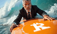 a man in a suit is riding a wave on an orange surfboard