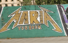 graffiti on a brick wall that says maria you rock