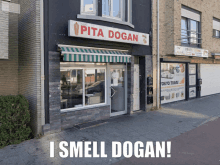 a sign for pita dogan is above the store