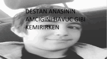 a black and white photo of a young boy with the words destan anasinin amcigini havuc gibi kemirirken written on the bottom