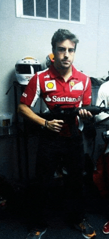 a man in a santander shirt is holding a camera